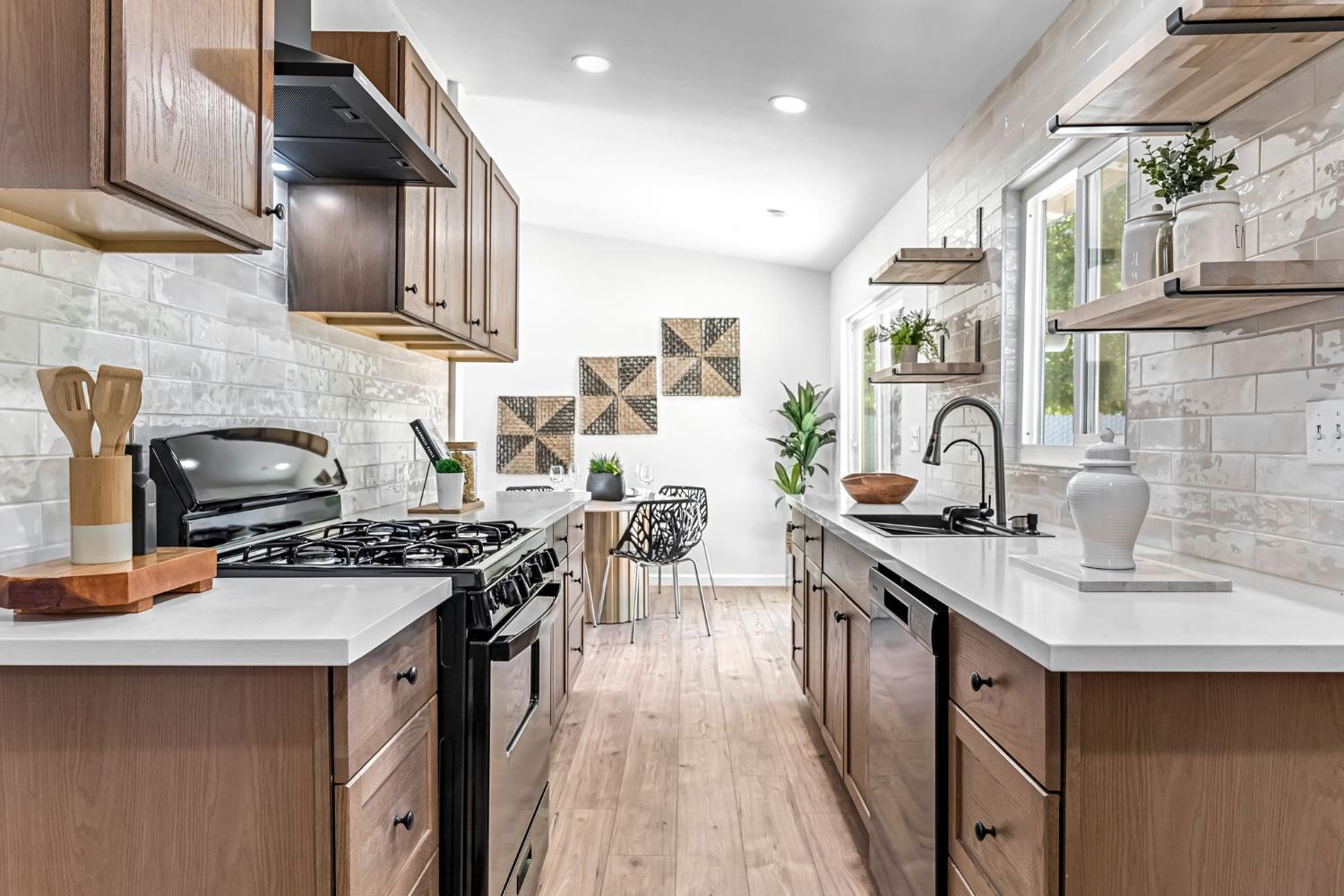 27208 Saunders Road Madera, CA 93637 - Photo 14 of 27 a kitchen with stainless steel appliances a sink stove and cabinets