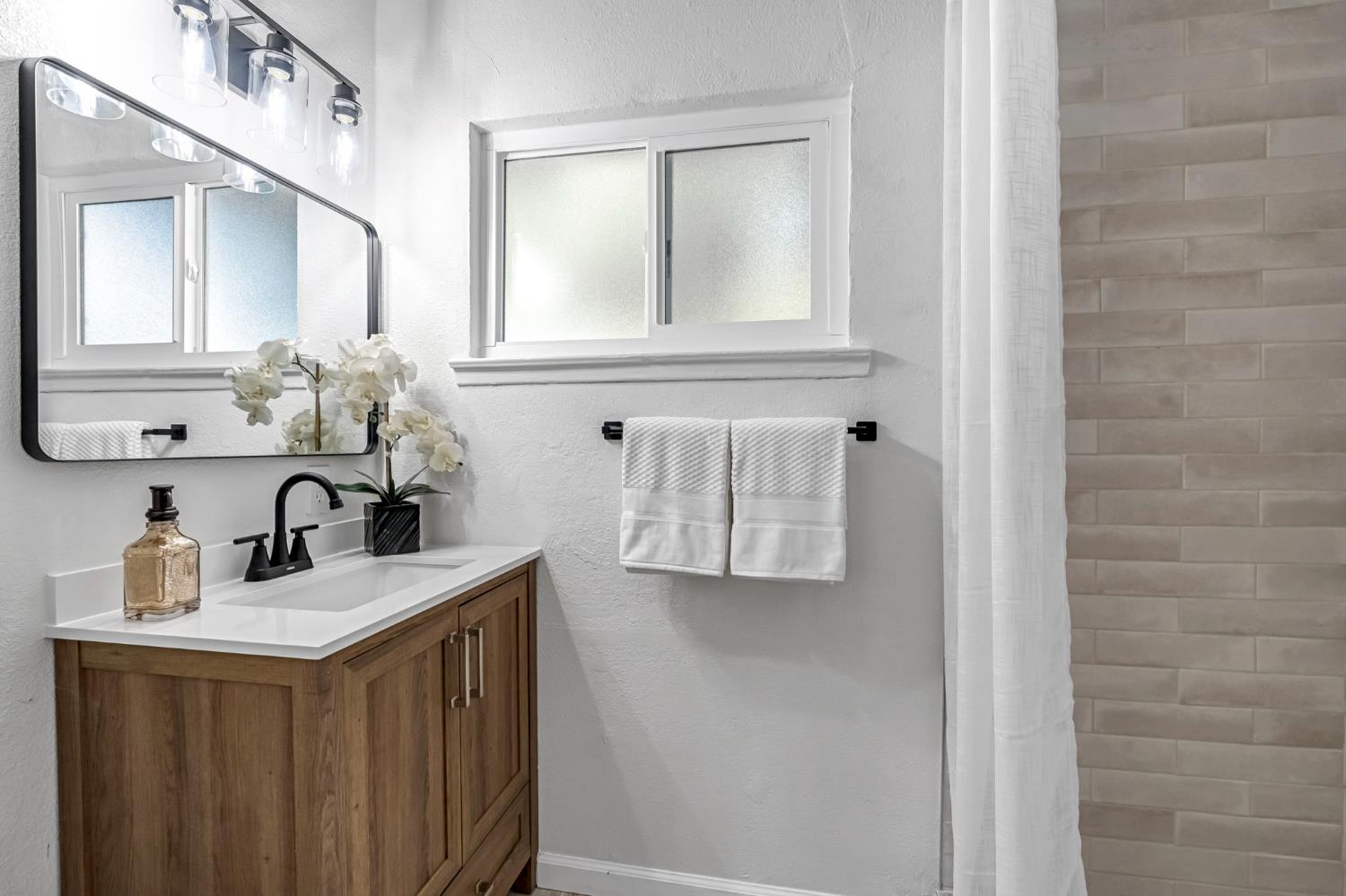 27208 Saunders Road Madera, CA 93637 - Photo 18 of 27 a bathroom with a sink vanity and mirror