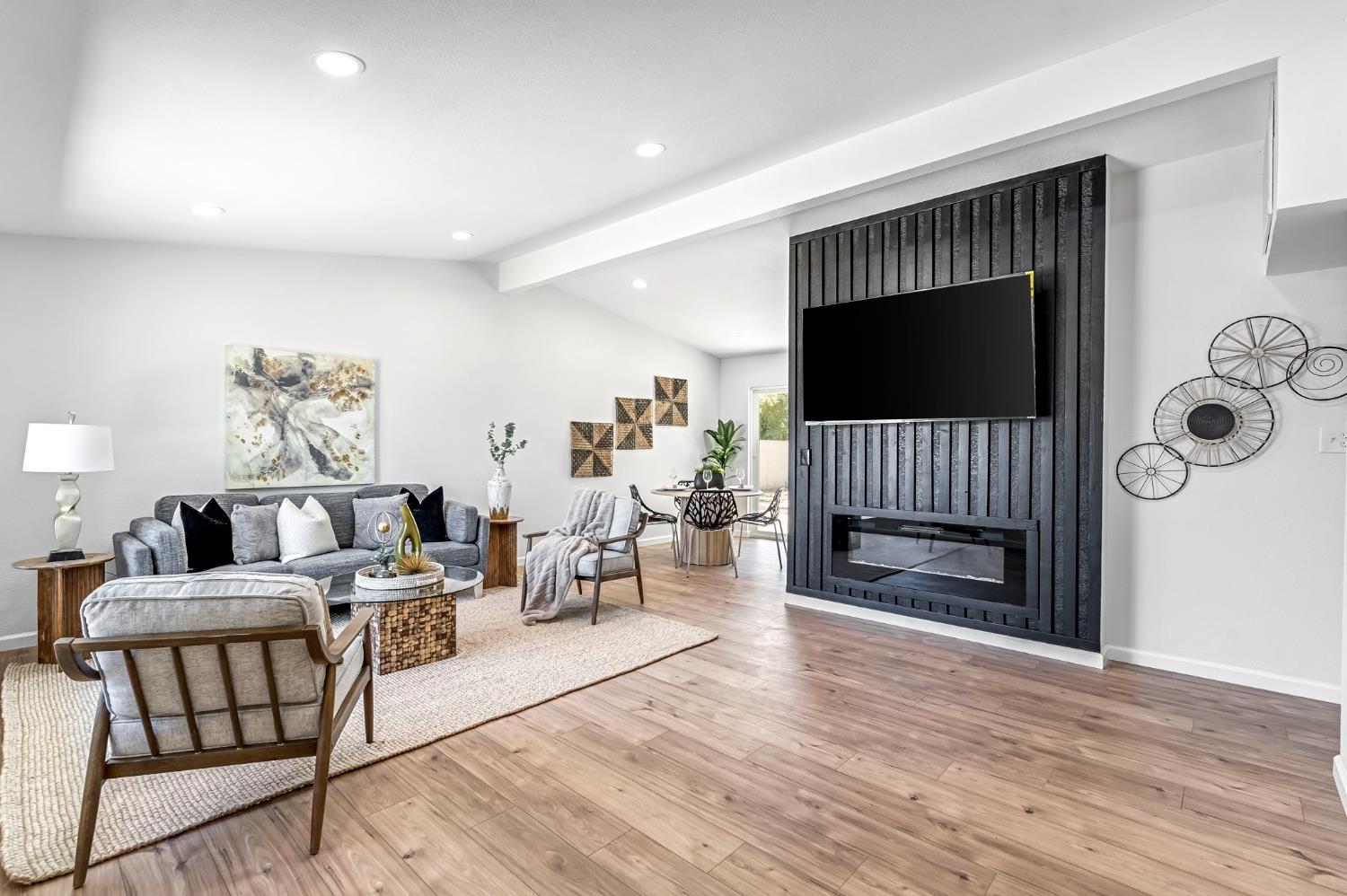 27208 Saunders Road Madera, CA 93637 - Photo 2 of 27 a living room with furniture a flat screen tv and a fireplace