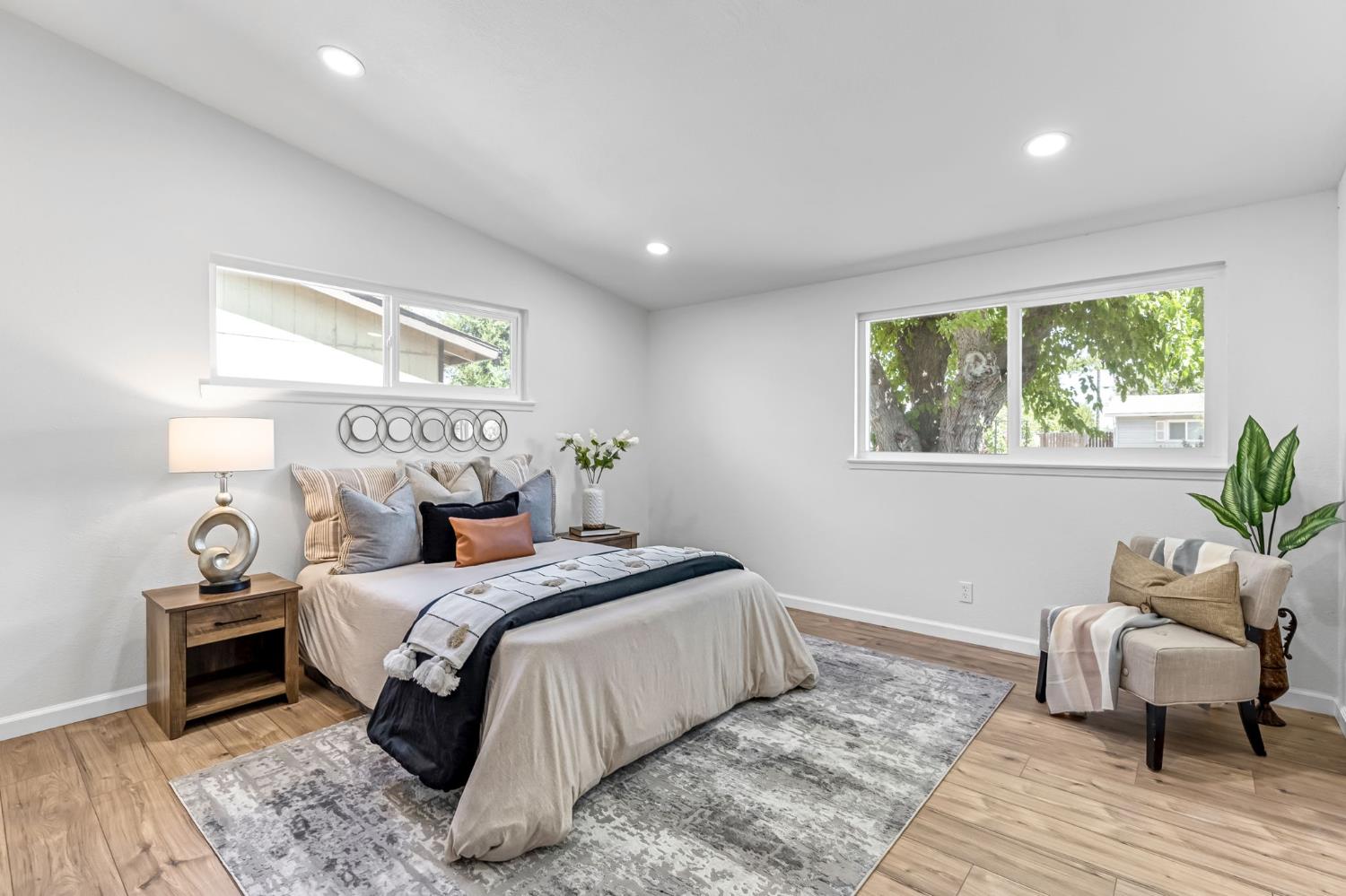 27208 Saunders Road Madera, CA 93637 - Photo 21 of 27 a bedroom with a bed and wooden floor