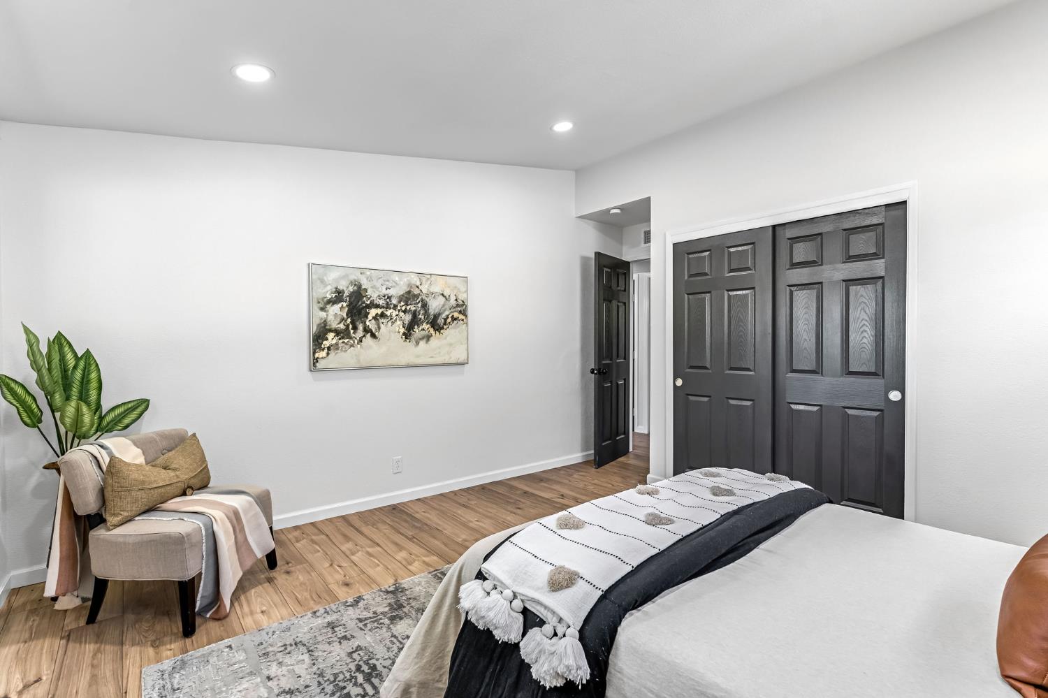 27208 Saunders Road Madera, CA 93637 - Photo 22 of 27 a bedroom with a bed and a couch