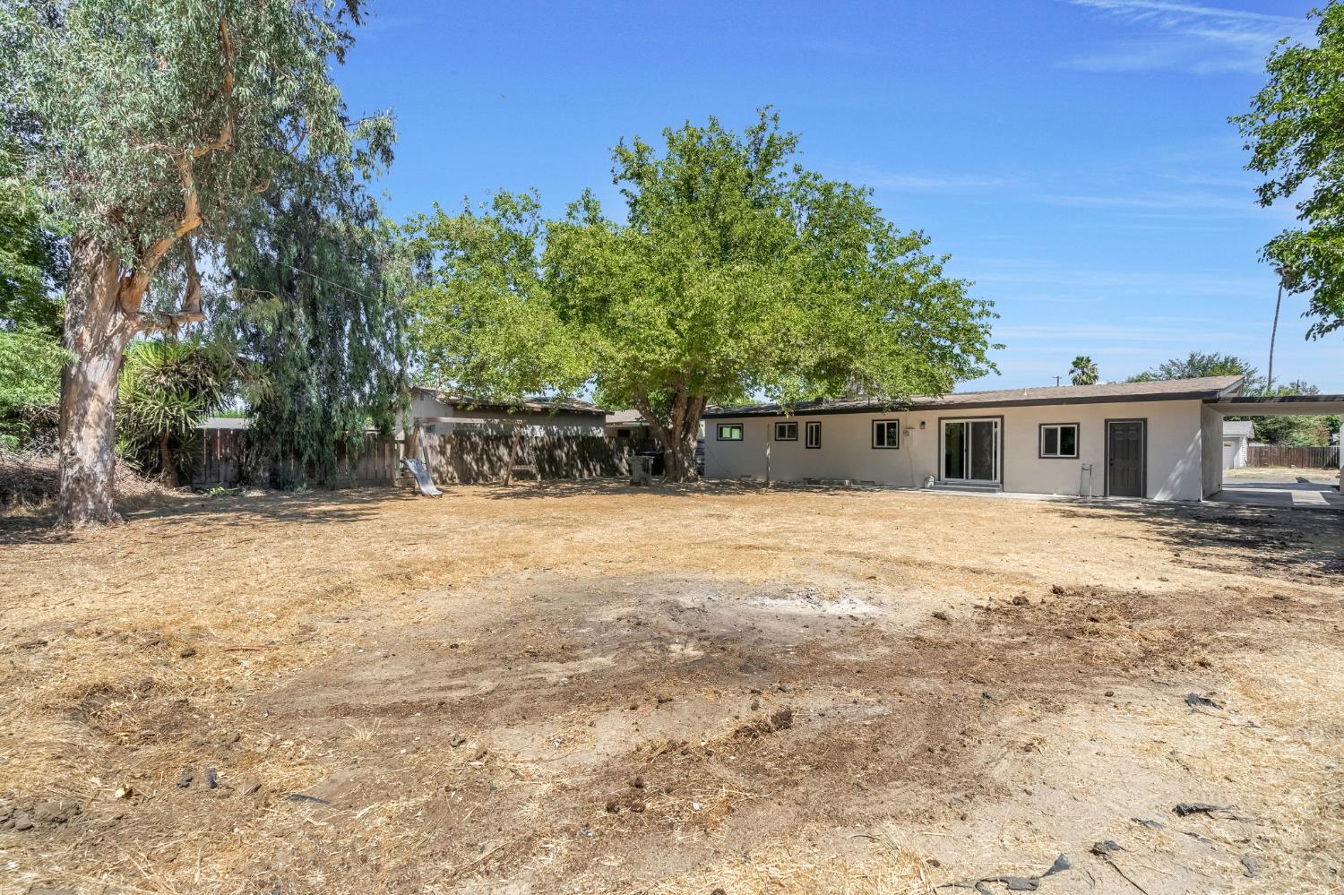 27208 Saunders Road Madera, CA 93637 - Photo 24 of 27 a front view of house with yard and trees in the background