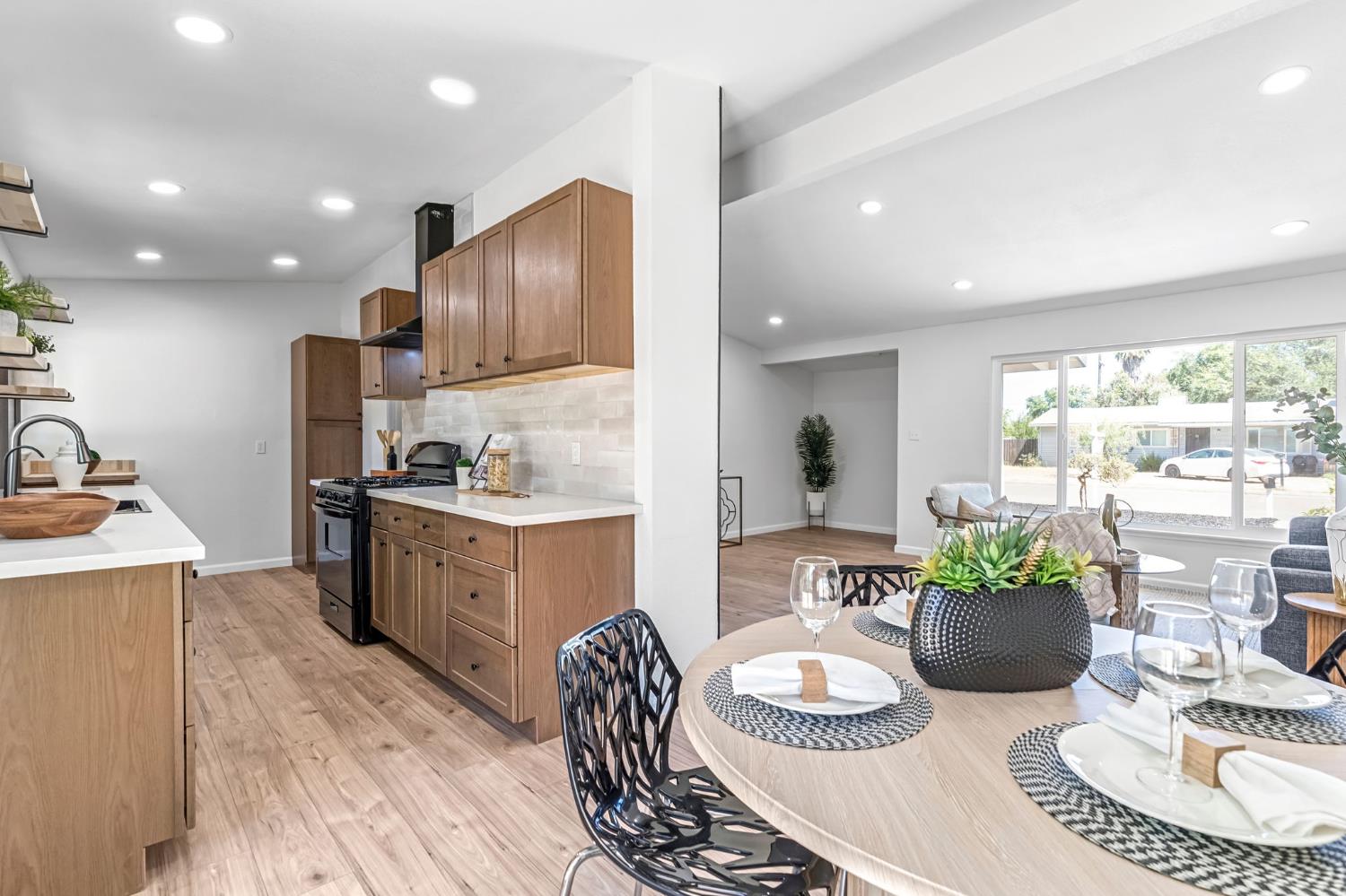 27208 Saunders Road Madera, CA 93637 - Photo 9 of 27 a kitchen with sink refrigerator dining table and chairs