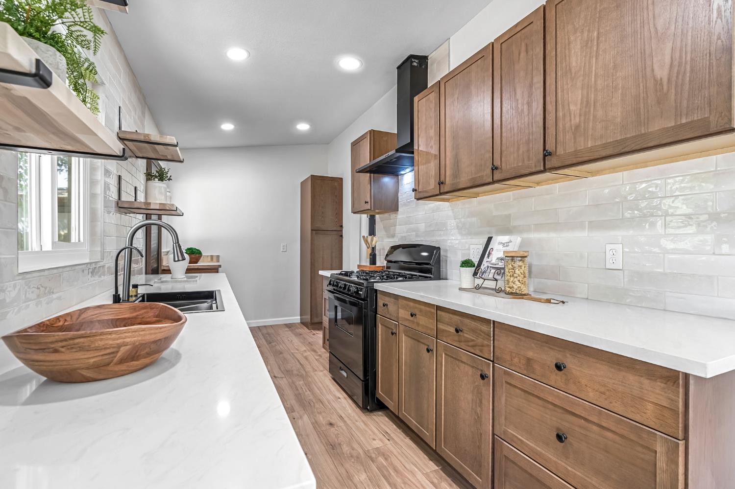 27208 Saunders Road Madera, CA 93637 - Photo 10 of 27 a kitchen with stainless steel appliances granite countertop a sink stove and refrigerator