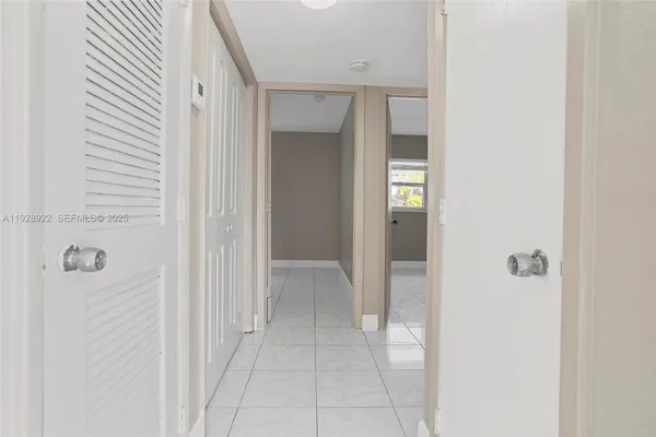 a view of a bathroom from a corridor