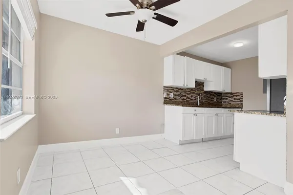 a kitchen with a refrigerator a stove top oven and cabinets