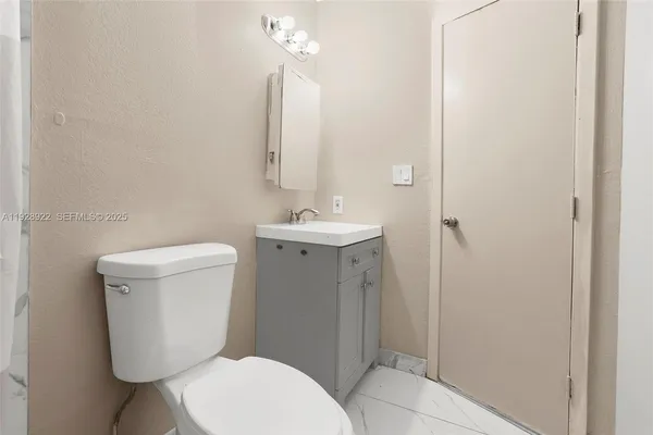 a bathroom with a toilet sink and shower