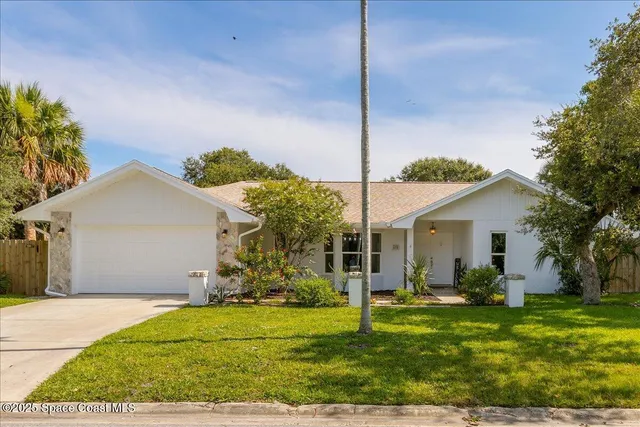 a backyard of a house with potted plants