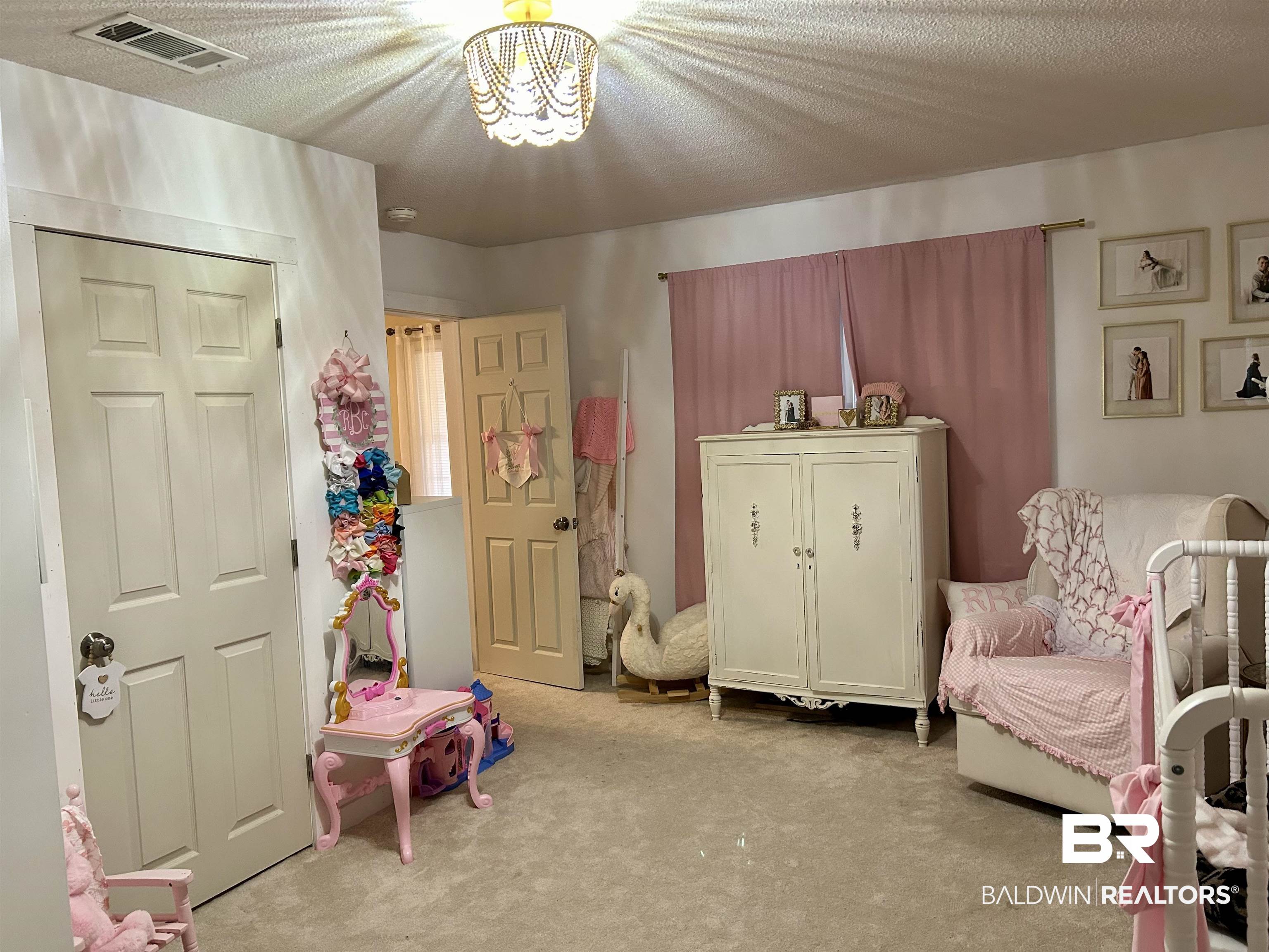 3850 Newman Road Mobile, AL 36695 - Photo 20 of 27 Living area featuring a textured ceiling and light carpet