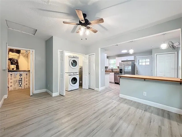 a kitchen with stainless steel appliances granite countertop a refrigerator and a stove top oven
