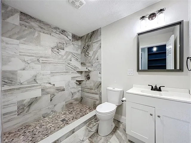 a view of a hallway with wooden floor and door