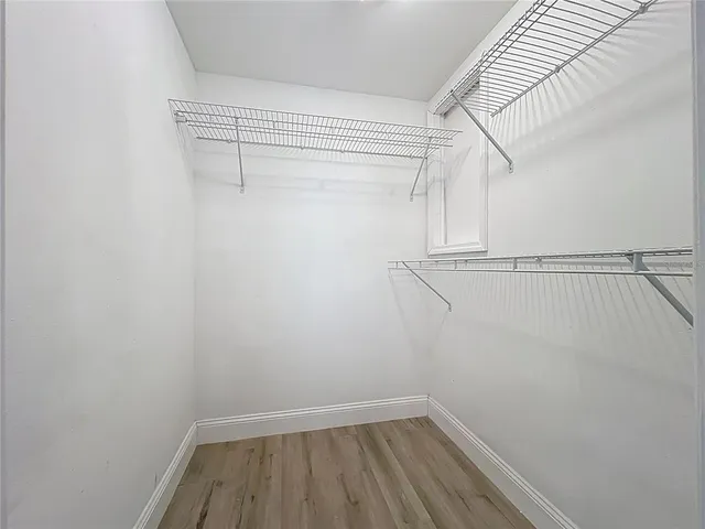 a view of a pathway of a house with potted plants