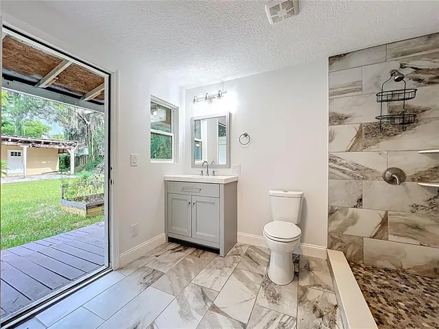 an aerial view of a house with a yard and garden