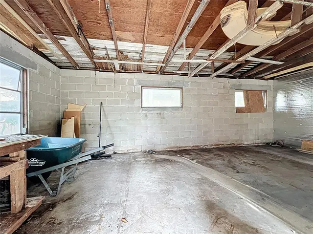 an aerial view of a house with a yard and lake view