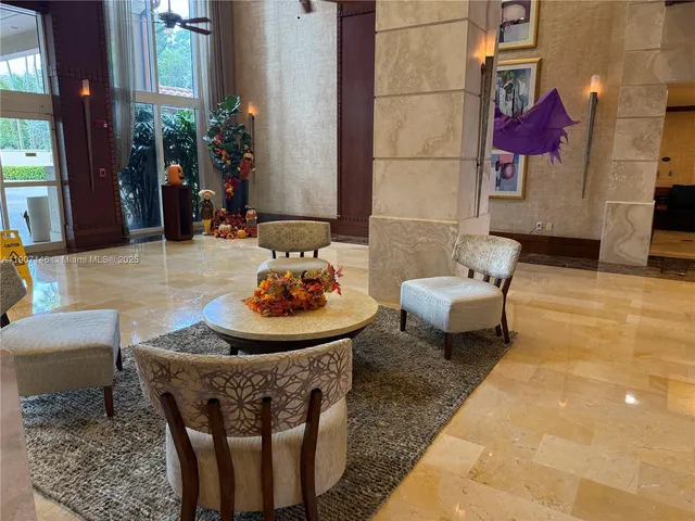 a living room with furniture and flowers