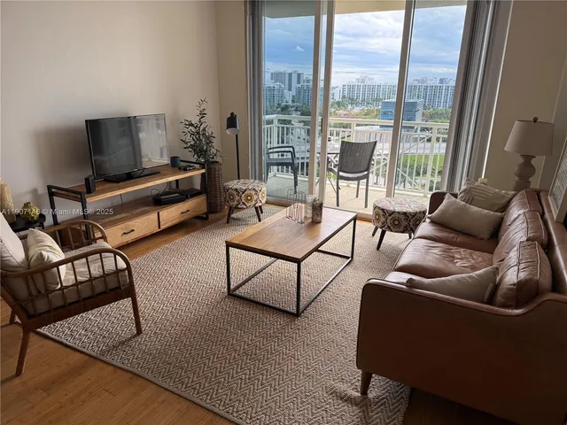 a living room with furniture and a floor to ceiling window