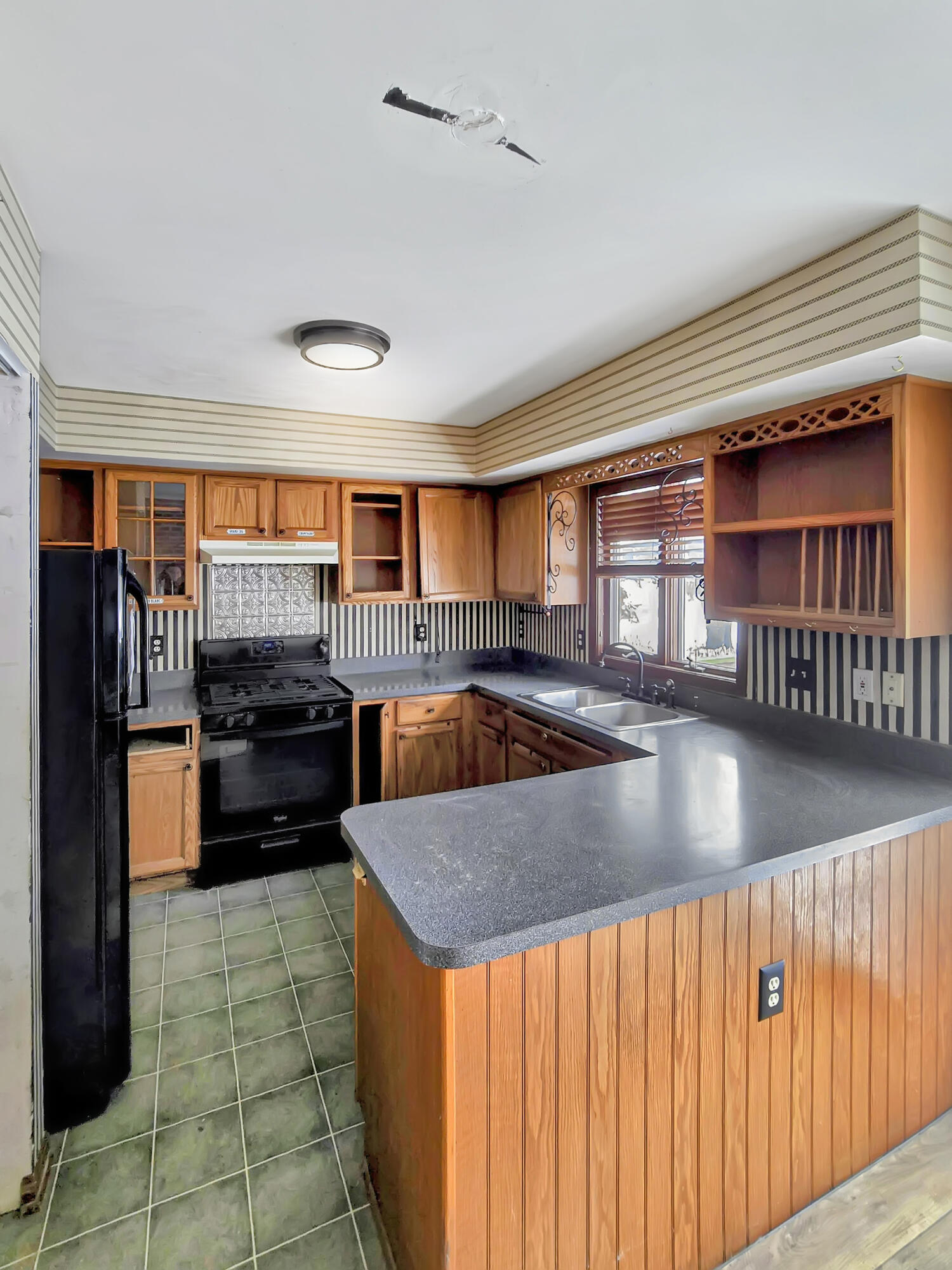1538 Lake Street Hobart, IN 46342 - Photo 3 of 13 a kitchen with stainless steel appliances granite countertop a refrigerator a sink dishwasher a stove and a dining table with wooden floor