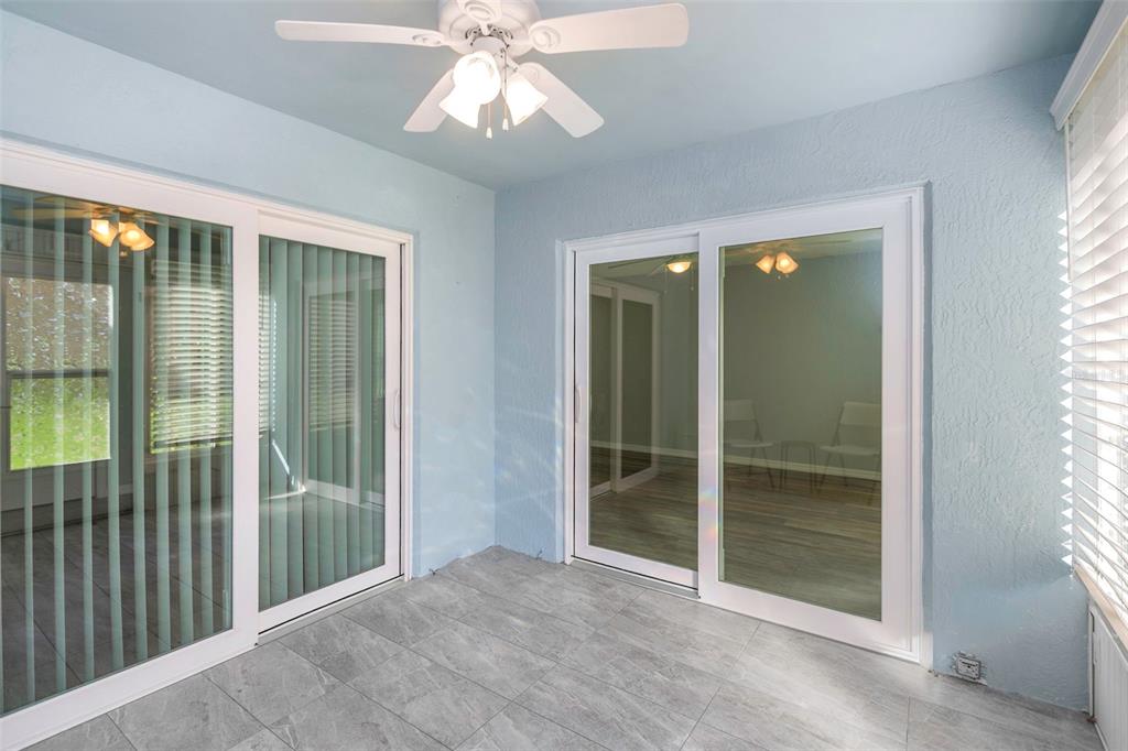 6520 Thicket Trail New Port Richey, FL 34653 - Photo 26 of 43 wooden floor in an empty room with a glass door