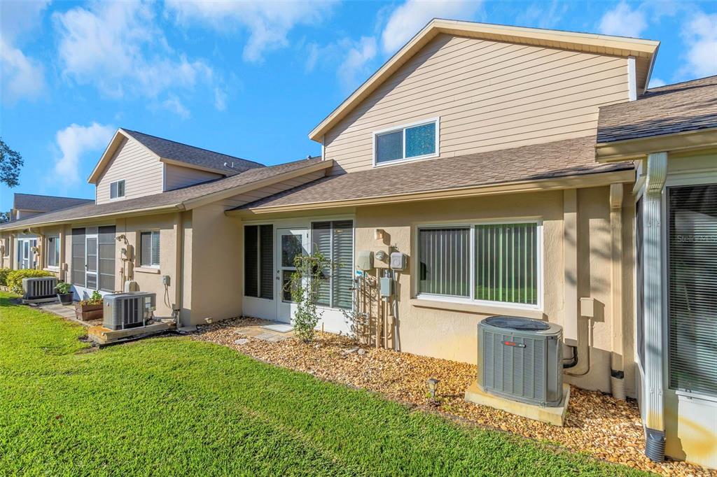 6520 Thicket Trail New Port Richey, FL 34653 - Photo 27 of 43 a view of a house with backyard porch and sitting area