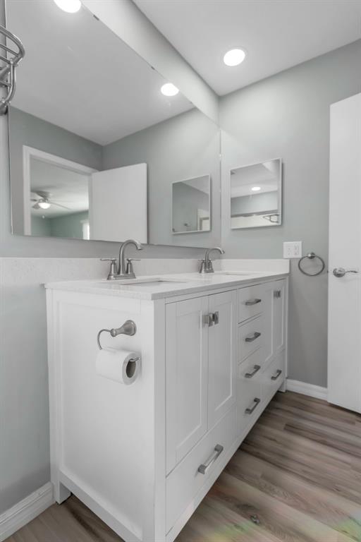 6520 Thicket Trail New Port Richey, FL 34653 - Photo 31 of 43 a spacious bathroom with a double vanity sink and mirror