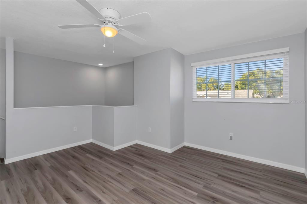 6520 Thicket Trail New Port Richey, FL 34653 - Photo 34 of 43 a view of empty room with wooden floor and fan