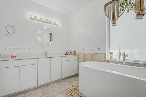 a room with a sink and a mirror