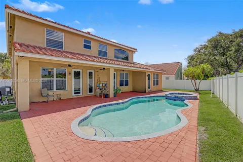 a front view of a house with swimming pool having outdoor seating
