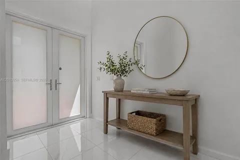 a living room with furniture and a mirror