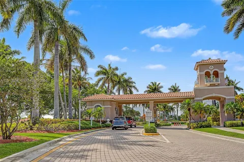 a front view of a building with palm trees