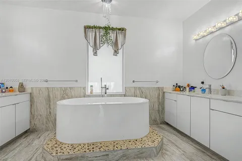 a room with a sink and chandelier
