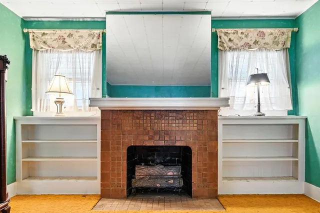 a living room with a fireplace and a window