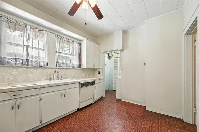 a view of a kitchen with a sink dishwasher and wooden floor