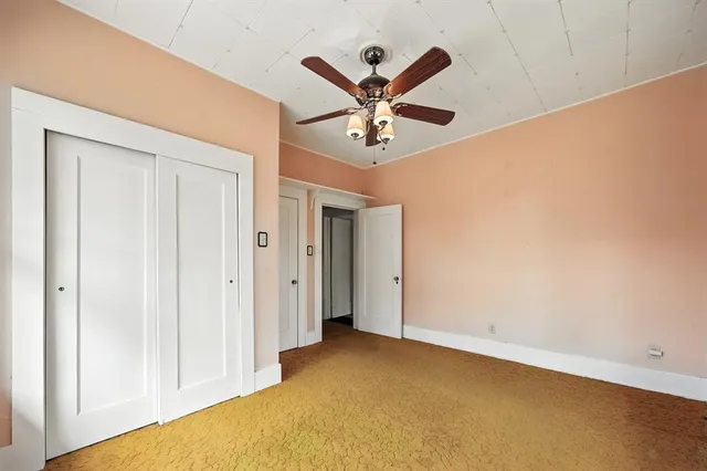a view of a big room with closet and ceiling fan