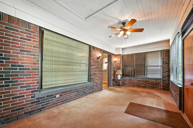 a view of a livingroom with a furniture and floor to ceiling window