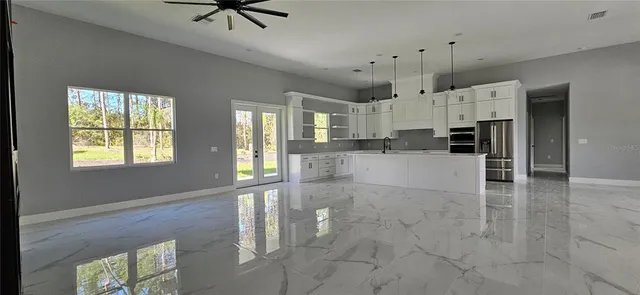 a view of a kitchen with wooden floor and a window