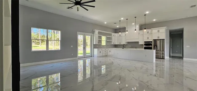 a view of kitchen with windows and ceiling fan