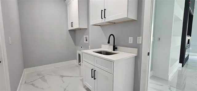 a kitchen with white cabinets and white appliances