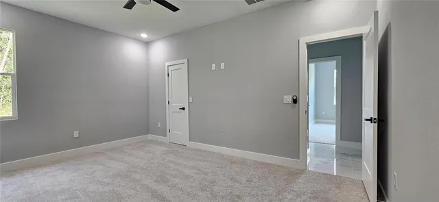 an empty room with closet and windows