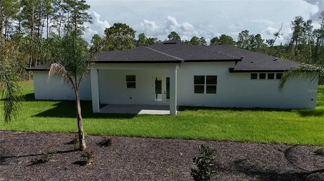 a view of a house with a backyard