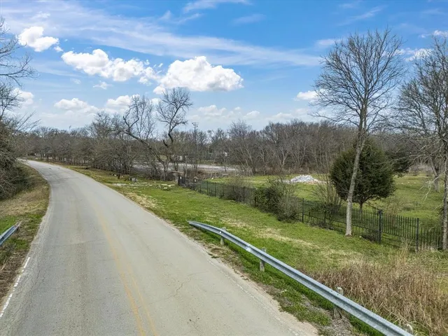 a view of a park with large trees