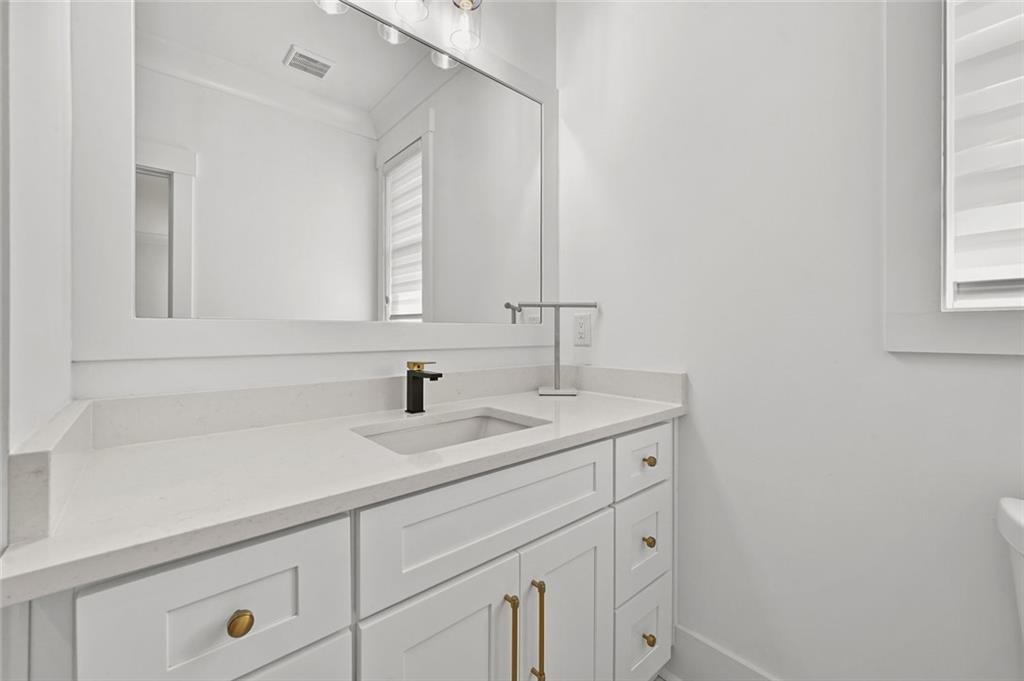 2694 Thompson Mill Road Buford, GA 30519 - Photo 60 of 70 a bathroom with a sink and a mirror