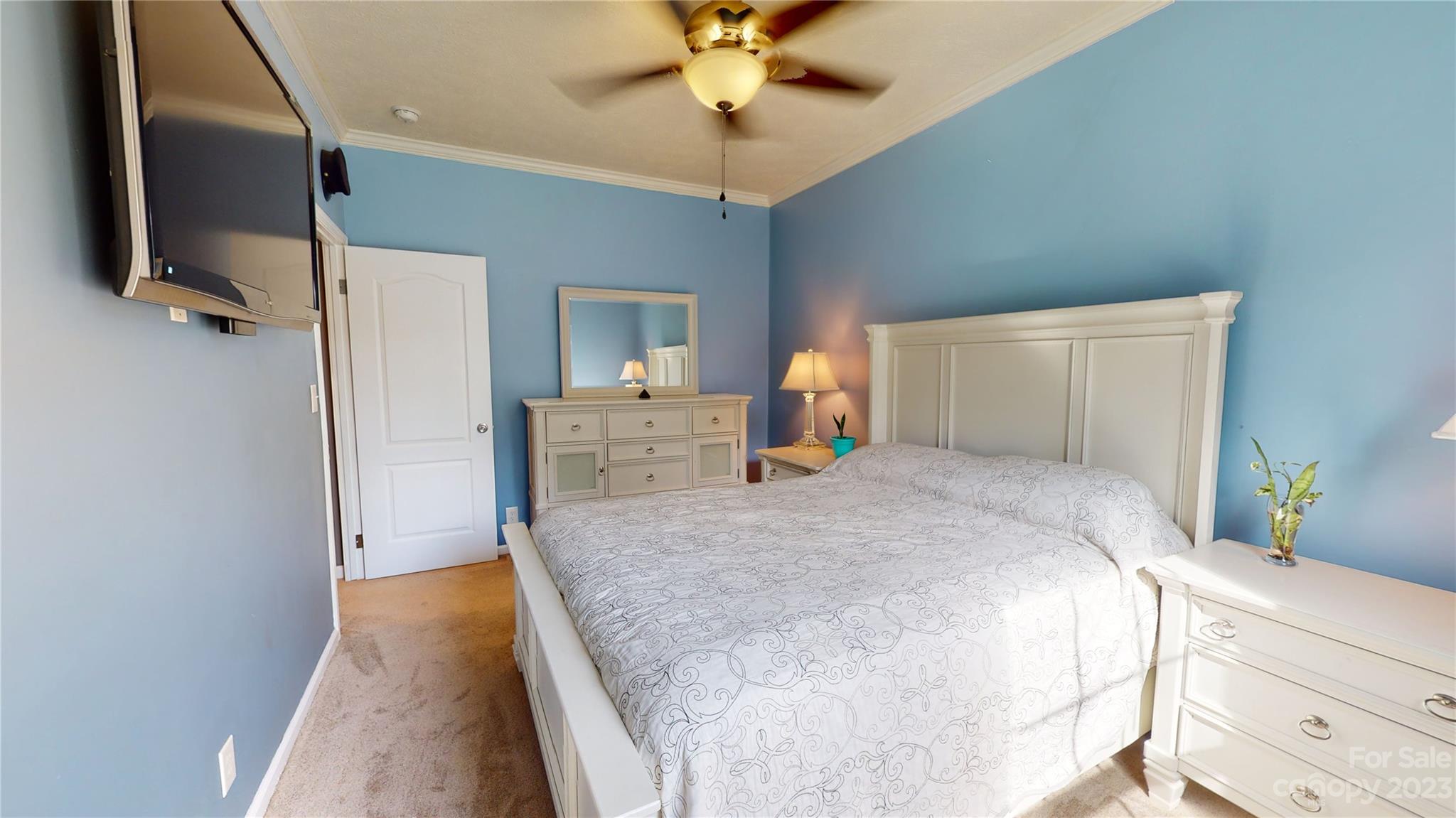 210 Mooseheart Ridge Marion, NC 28752 - Photo 19 of 37 a spacious bedroom with a bed and a chandelier