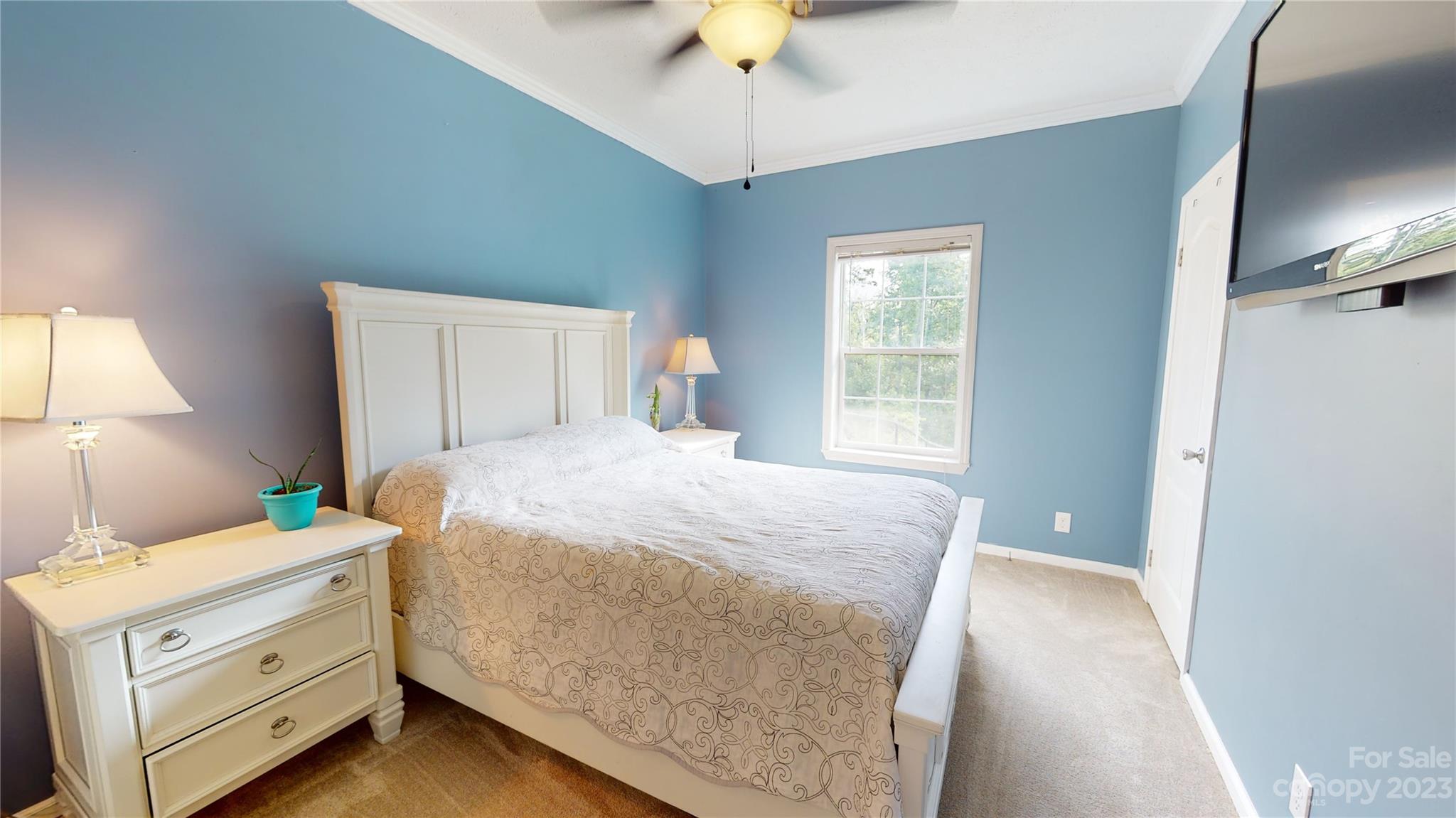 210 Mooseheart Ridge Marion, NC 28752 - Photo 20 of 37 a bedroom with a bed and a chandelier