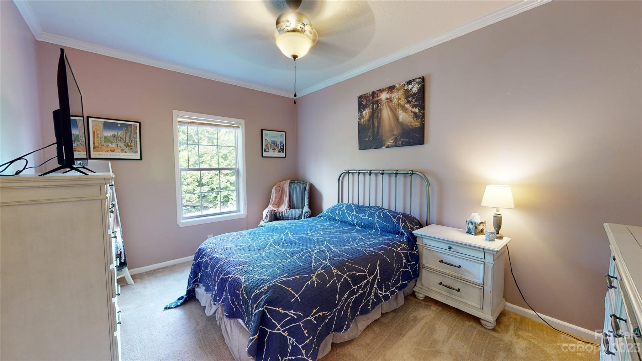210 Mooseheart Ridge Marion, NC 28752 - Photo 21 of 37 a bedroom with a bed and a chandelier