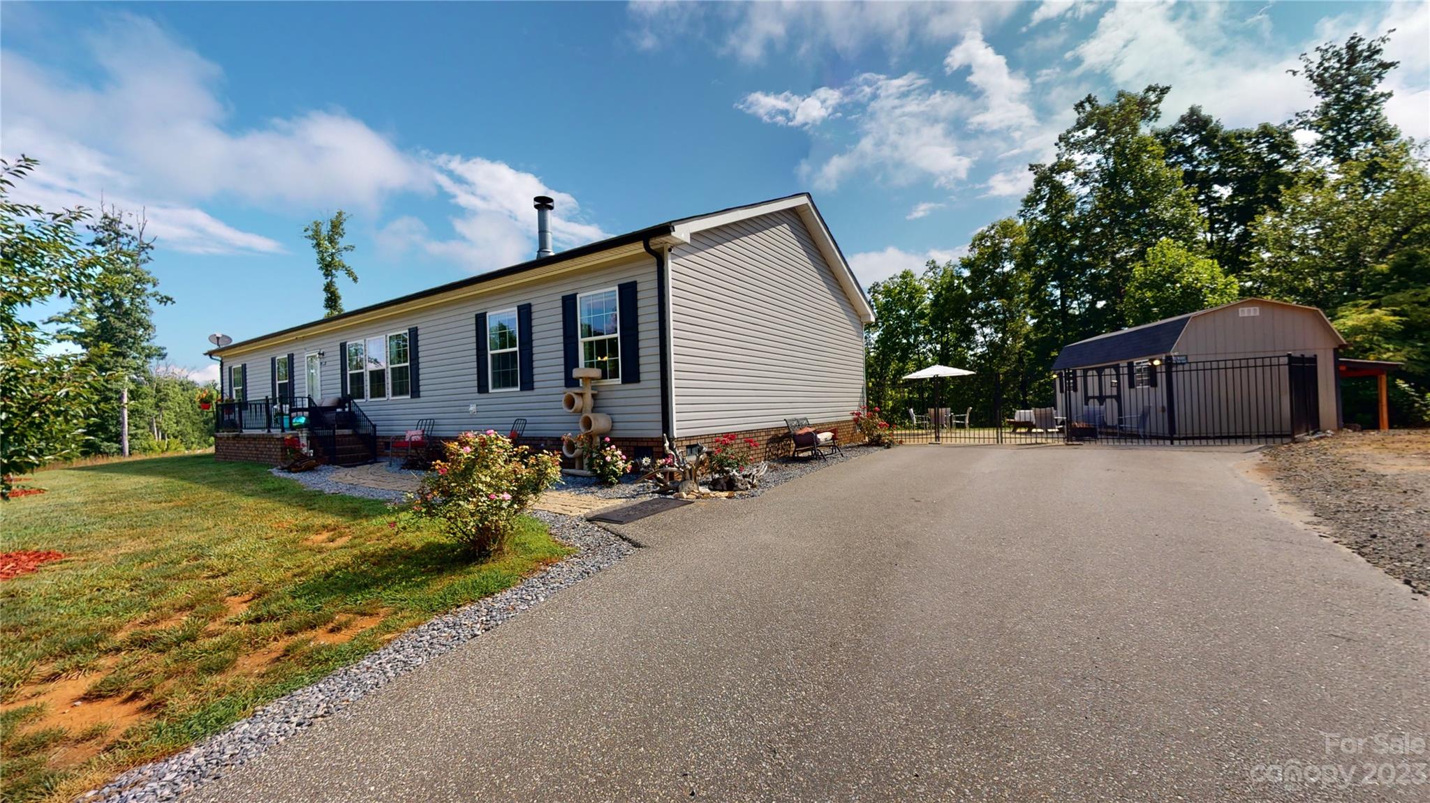 210 Mooseheart Ridge Marion, NC 28752 - Photo 29 of 37 a front view of house with yard and trees in the background