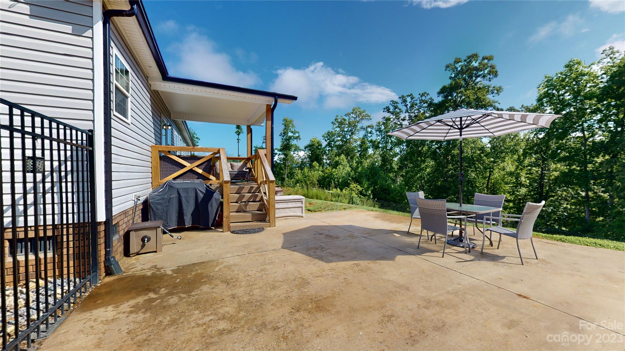 210 Mooseheart Ridge Marion, NC 28752 - Photo 32 of 37 a view of a patio with a table and chairs under an umbrella