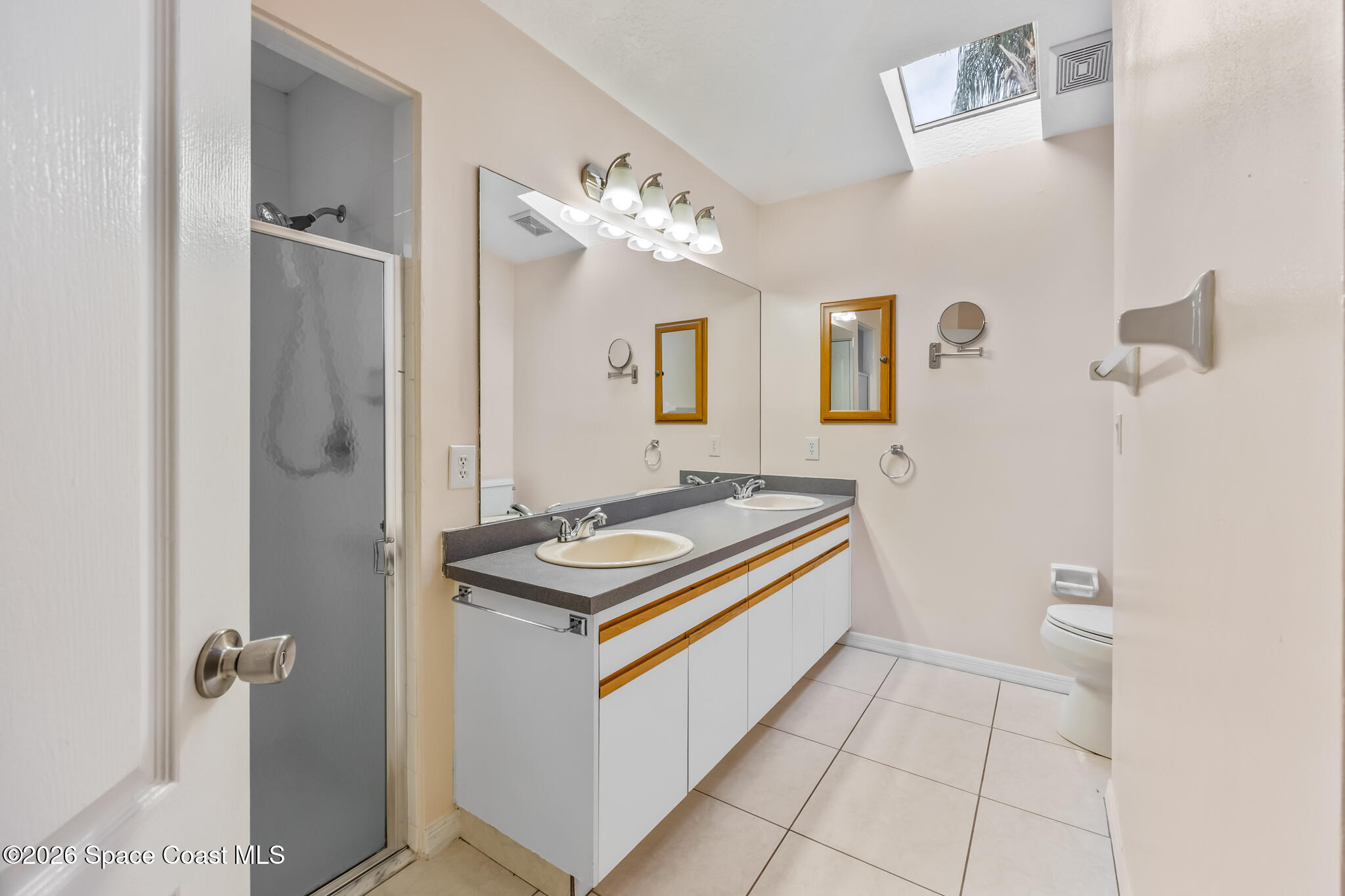 4600 Comfort Street Cocoa, FL 32927 - Photo 14 of 29 a bathroom with a sink a toilet and mirror