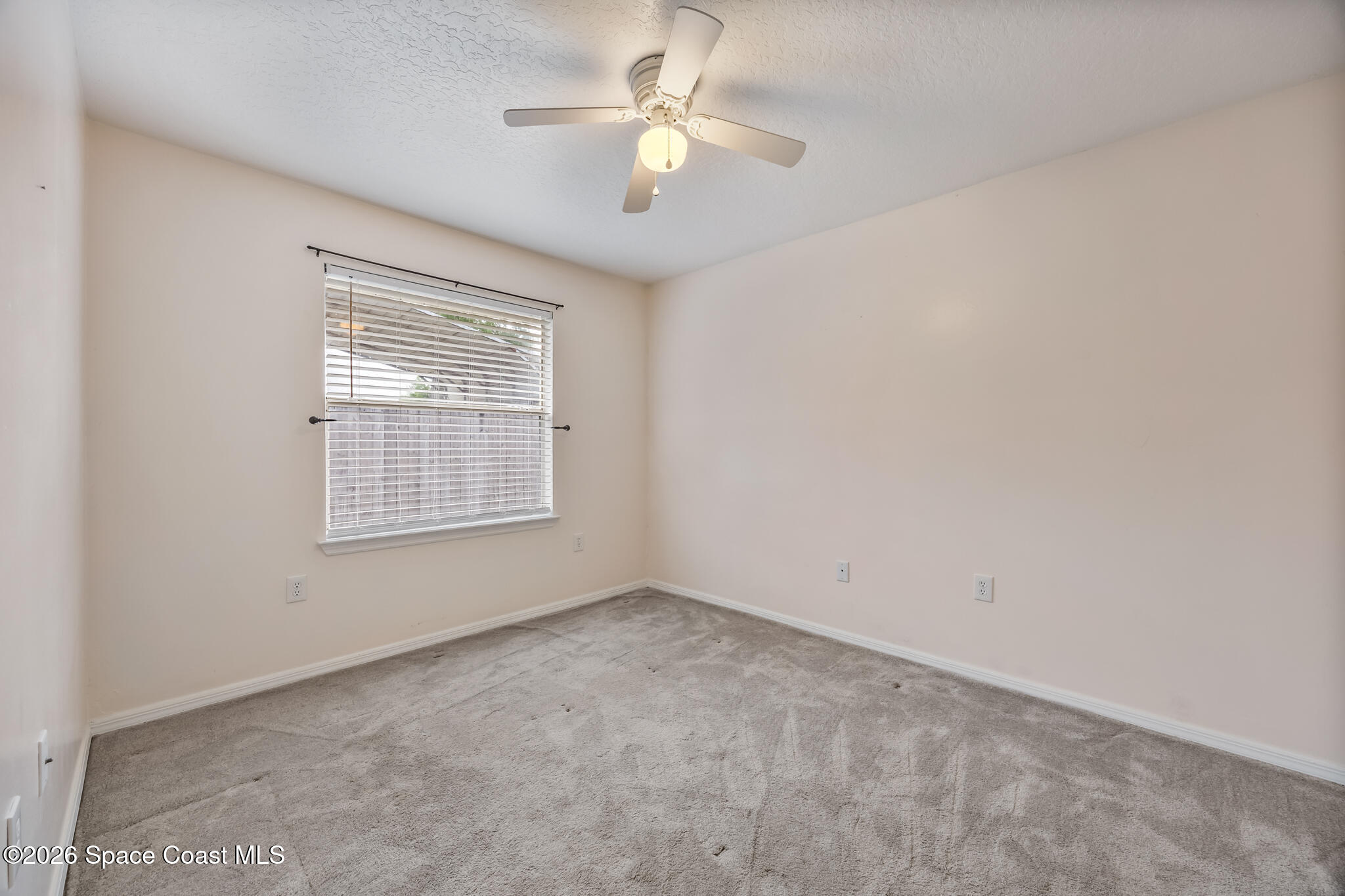 4600 Comfort Street Cocoa, FL 32927 - Photo 17 of 29 an empty room with a window and a ceiling fan