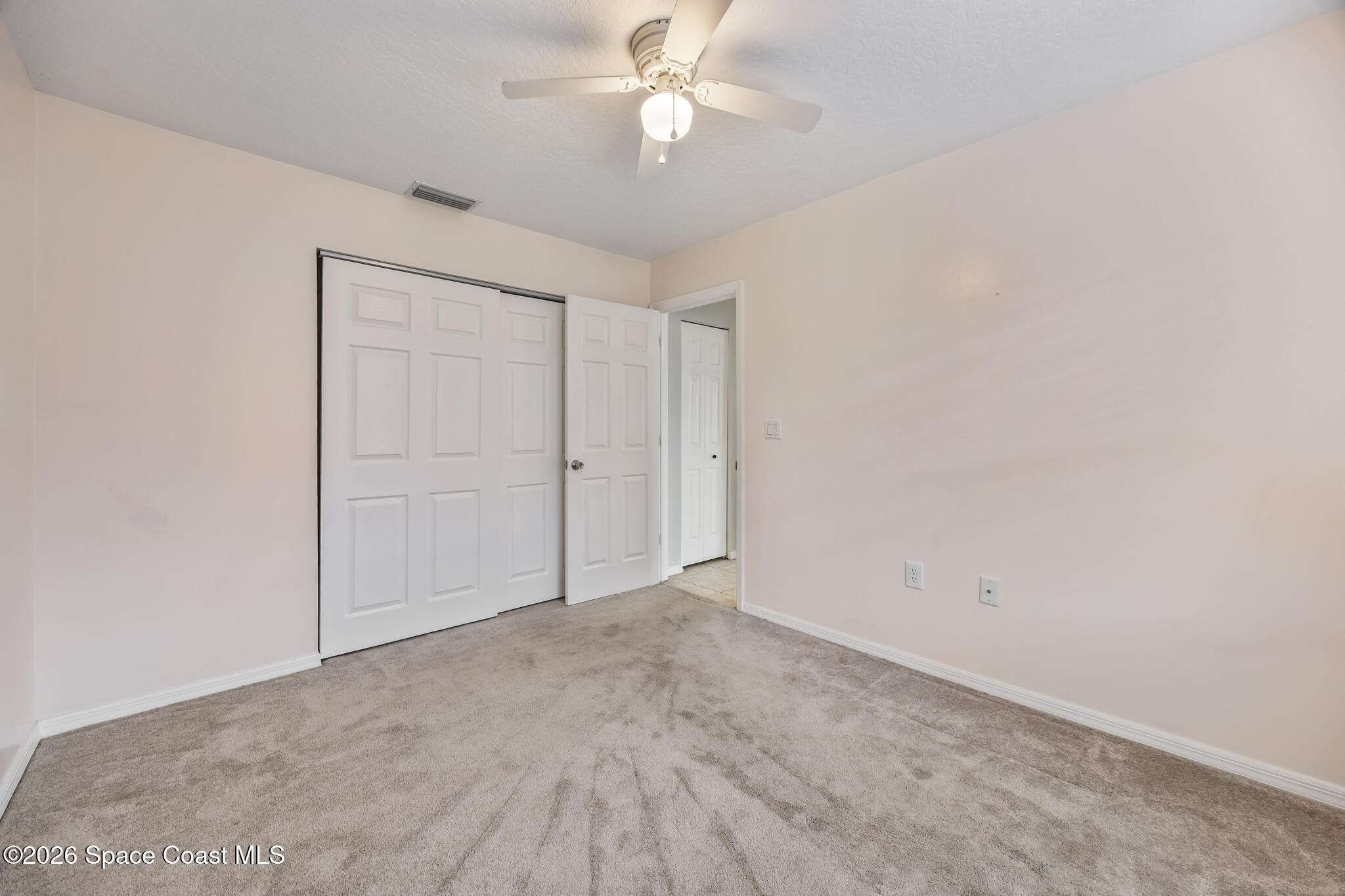 4600 Comfort Street Cocoa, FL 32927 - Photo 18 of 29 an empty room with closet and a chandelier fan