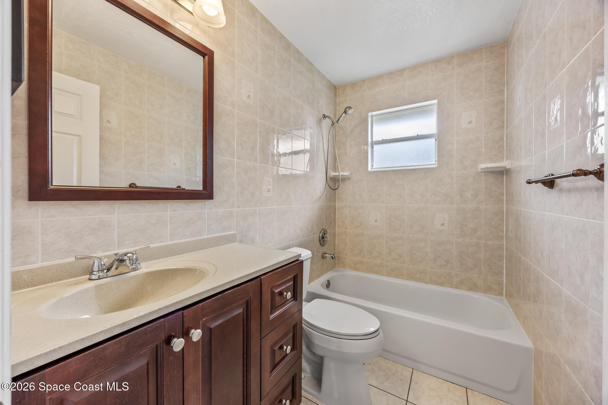 4600 Comfort Street Cocoa, FL 32927 - Photo 19 of 29 a bathroom with a sink a toilet a mirror a bathtub and shower